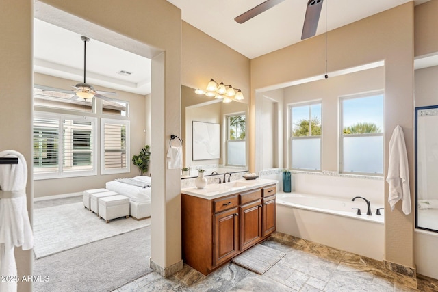 bathroom with vanity, ceiling fan, and a tub