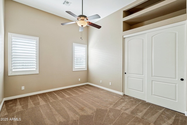 unfurnished bedroom with carpet flooring, ceiling fan, and a closet