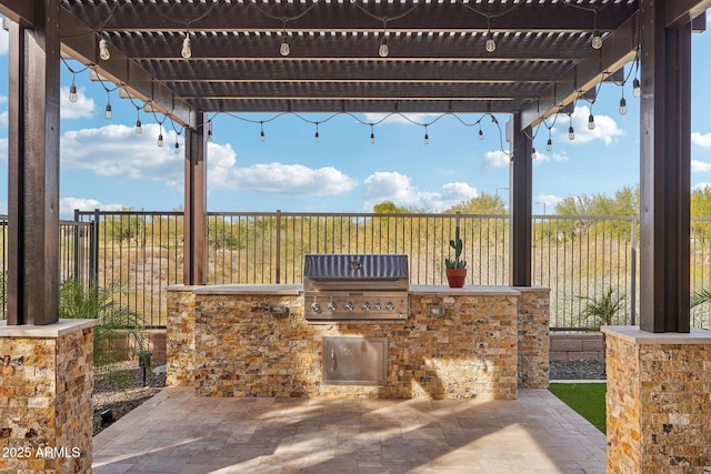 view of patio featuring an outdoor kitchen, a pergola, and grilling area