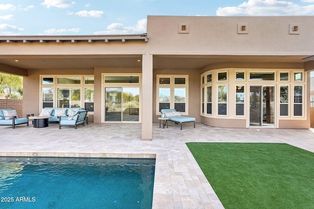 rear view of property featuring a patio and an outdoor hangout area