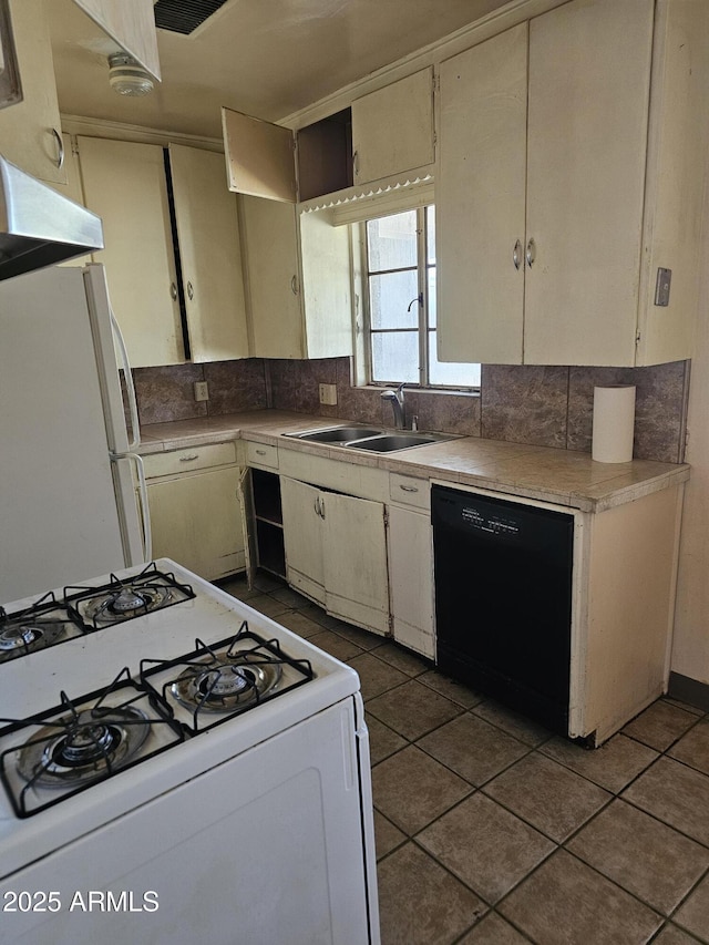 1630 E Catalina Dr, Phoenix, AZ 85016 - kitchen with white appliances, a sink, light countertops, decorative backsplash, and dark tile patterned floors