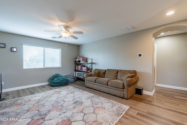 living room featuring ceiling fan and light hardwood / wood-style flooring