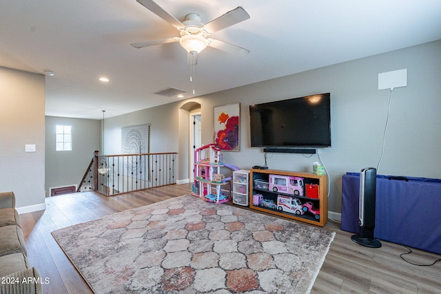 living room featuring light wood-type flooring and ceiling fan