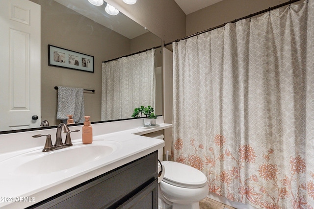 bathroom with tile patterned flooring, a shower with curtain, vanity, and toilet