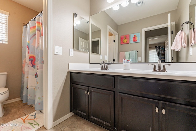 bathroom featuring vanity, tile patterned flooring, and toilet