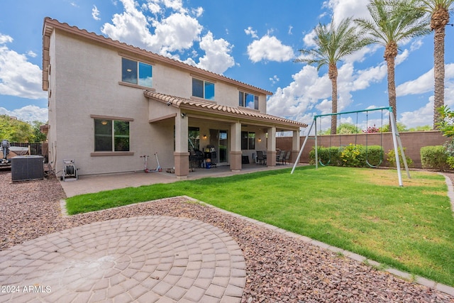 back of property featuring a lawn, a patio, and central AC unit