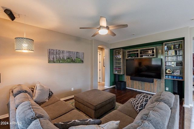 living room featuring ceiling fan and dark hardwood / wood-style flooring