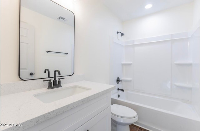 full bathroom with washtub / shower combination, vanity, hardwood / wood-style flooring, and toilet