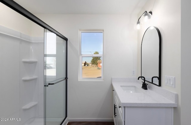 bathroom featuring vanity and a shower with shower door