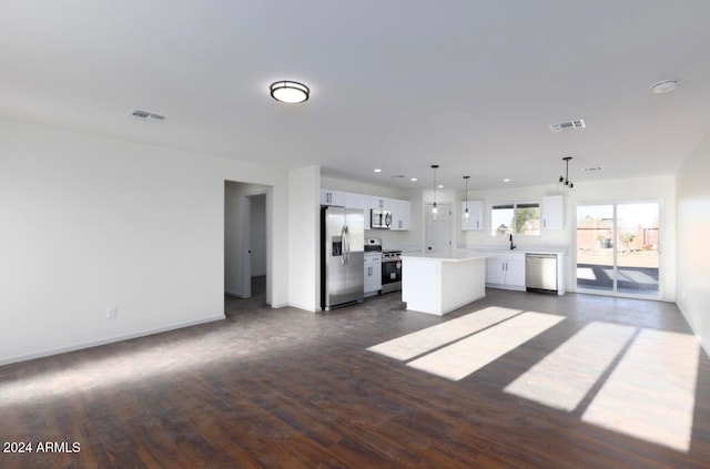 unfurnished living room featuring dark wood-type flooring and sink