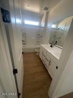 full bathroom with toilet, wood-type flooring, vanity, and tub / shower combination