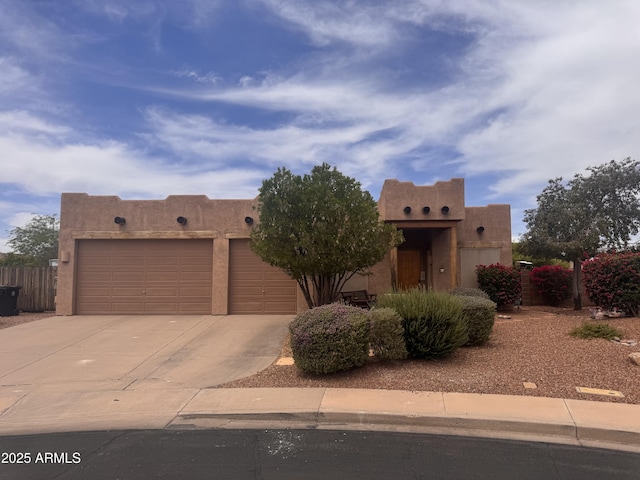 1428 N Leandro Cir, Mesa, AZ 85207 - pueblo revival-style home featuring concrete driveway, a garage, and stucco siding