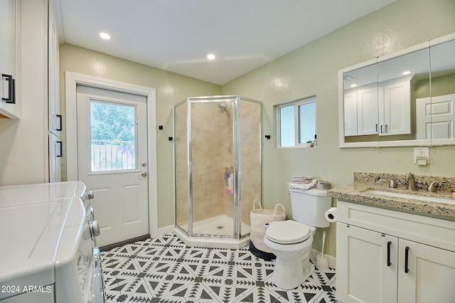 8049 N 16th Ave, Phoenix, AZ 85021 - full bathroom featuring vanity, independent washer and dryer, toilet, a shower stall, and baseboards