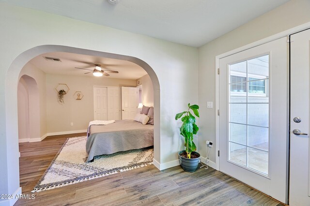 8049 N 16th Ave, Phoenix, AZ 85021 - bedroom featuring arched walkways, wood finished floors, and baseboards