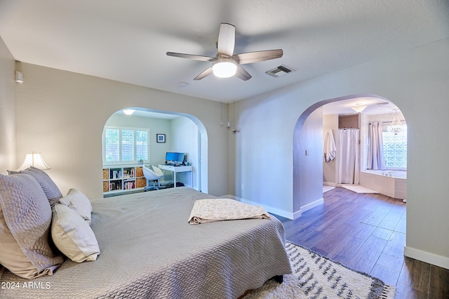 8049 N 16th Ave, Phoenix, AZ 85021 - bedroom featuring arched walkways, multiple windows, wood finished floors, and baseboards