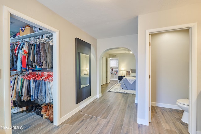 8049 N 16th Ave, Phoenix, AZ 85021 - hall featuring arched walkways, wood finished floors, and baseboards