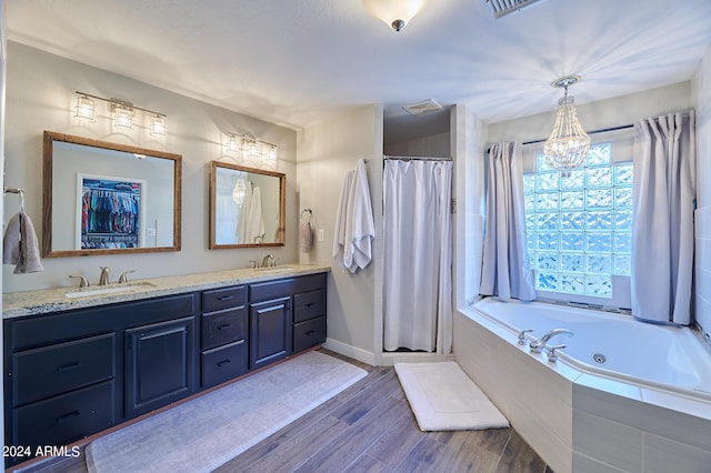 8049 N 16th Ave, Phoenix, AZ 85021 - bathroom featuring a stall shower, a jetted tub, wood finished floors, and plenty of natural light