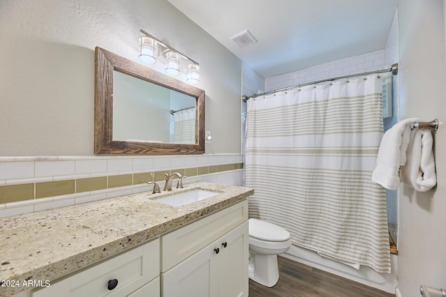 8049 N 16th Ave, Phoenix, AZ 85021 - full bathroom featuring vanity, toilet, wood finished floors, shower / tub combo, and tile walls