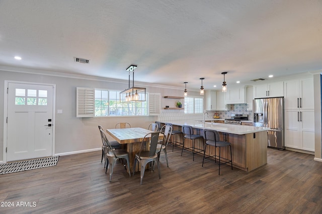 8049 N 16th Ave, Phoenix, AZ 85021 - dining room with recessed lighting, dark wood finished floors, plenty of natural light, and ornamental molding
