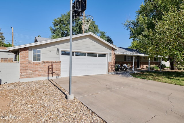 8049 N 16th Ave, Phoenix, AZ 85021 - ranch-style home featuring brick siding, an attached garage, and driveway