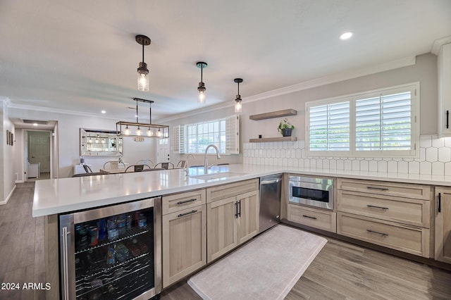 8049 N 16th Ave, Phoenix, AZ 85021 - kitchen with beverage cooler, a sink, stainless steel dishwasher, a peninsula, and light countertops