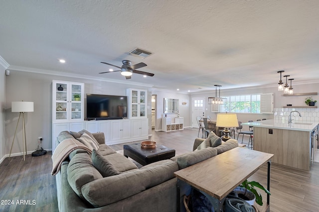 8049 N 16th Ave, Phoenix, AZ 85021 - living area with light wood-style floors, baseboards, recessed lighting, ornamental molding, and a ceiling fan