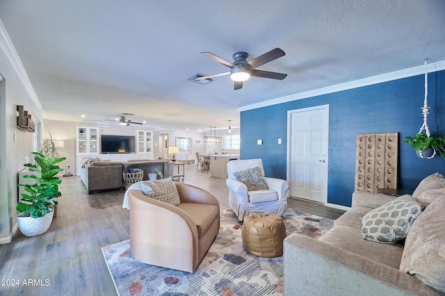 8049 N 16th Ave, Phoenix, AZ 85021 - living room featuring a ceiling fan, wood finished floors, ornamental molding, and baseboards