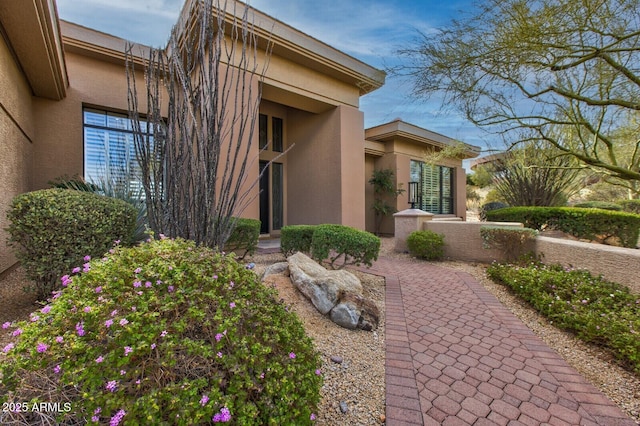 view of side of home with stucco siding