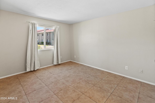 unfurnished room featuring light tile patterned floors