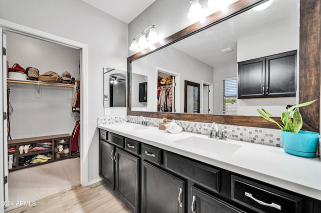 bathroom featuring double vanity and hardwood / wood-style floors