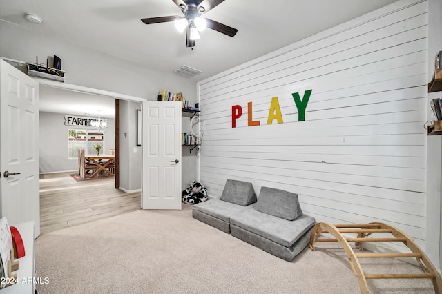 sitting room with ceiling fan and light hardwood / wood-style flooring