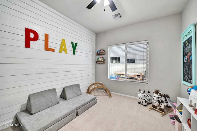 living area featuring ceiling fan and carpet floors