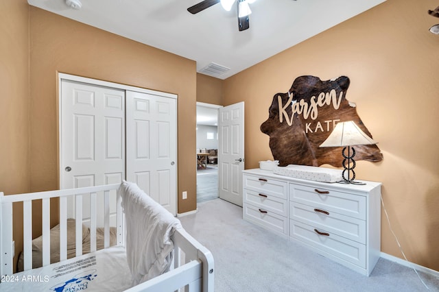 carpeted bedroom featuring ceiling fan and a closet