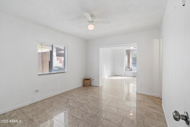 unfurnished room with a textured ceiling and ceiling fan