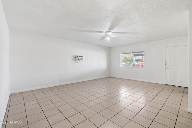 unfurnished room with ceiling fan and a textured ceiling