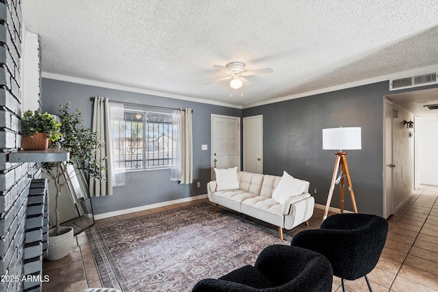 tiled living room featuring a textured ceiling, ornamental molding, and ceiling fan