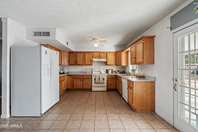 kitchen featuring light tile patterned flooring, sink, white appliances, ceiling fan, and a textured ceiling