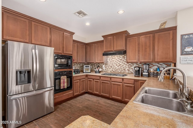 kitchen with black appliances, dark hardwood / wood-style floors, sink, and tasteful backsplash