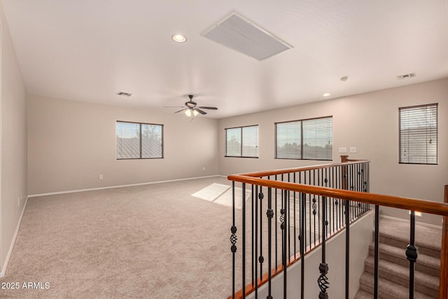 unfurnished room featuring ceiling fan and carpet