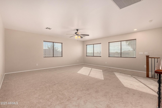 spare room featuring ceiling fan and light colored carpet