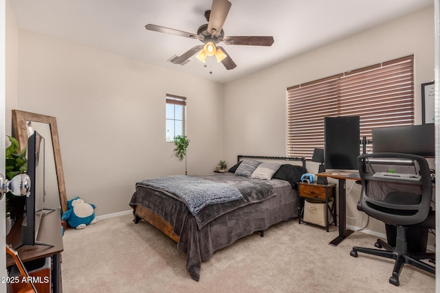 bedroom featuring ceiling fan and light carpet