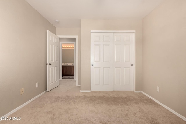 unfurnished bedroom with light carpet and a closet