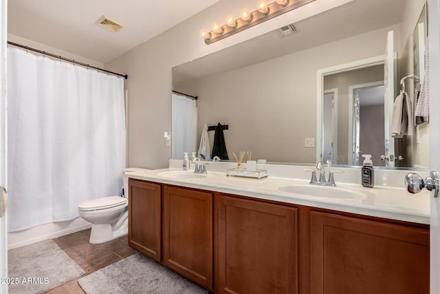 full bathroom with toilet, vanity, shower / tub combo with curtain, and tile patterned flooring