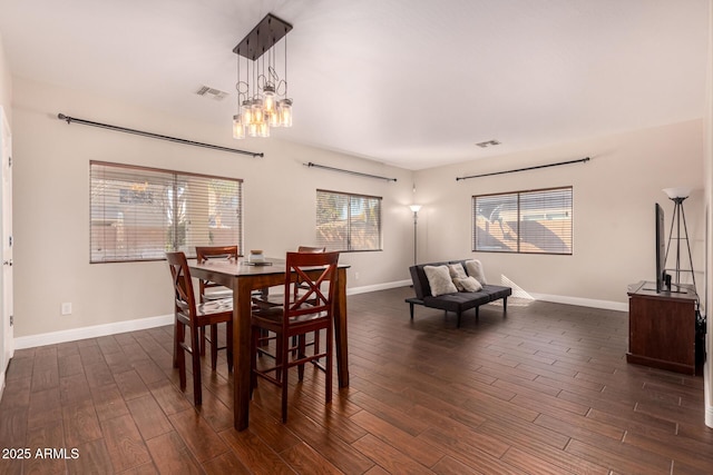 dining space with plenty of natural light and an inviting chandelier