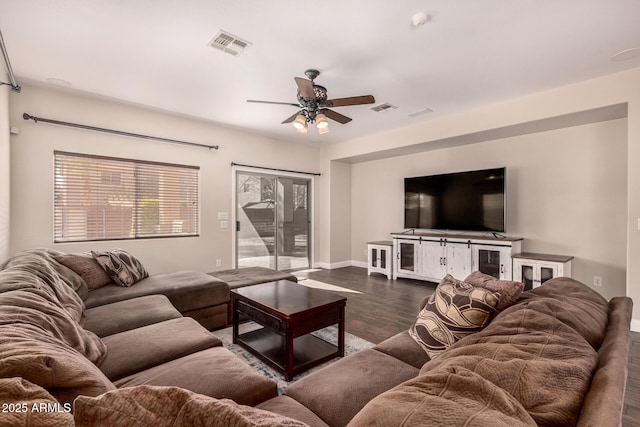 living room with ceiling fan and dark hardwood / wood-style flooring