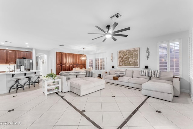 living room with light tile patterned floors and ceiling fan