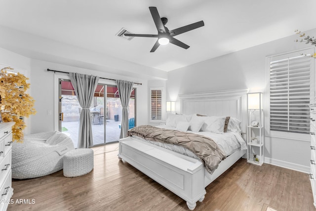 bedroom featuring hardwood / wood-style flooring, access to outside, and ceiling fan