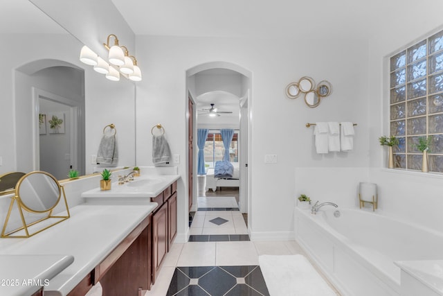 bathroom with vanity, a tub to relax in, tile patterned floors, and ceiling fan