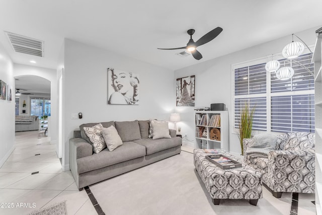 tiled living room with ceiling fan