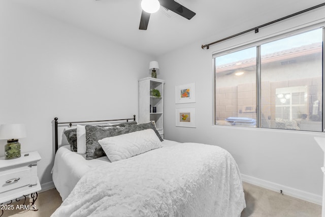 bedroom with ceiling fan and light colored carpet